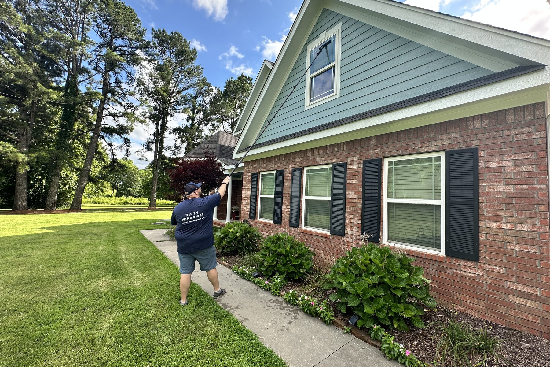 Jonathan cleaning windows on a residential home in South-Central Oklahoma